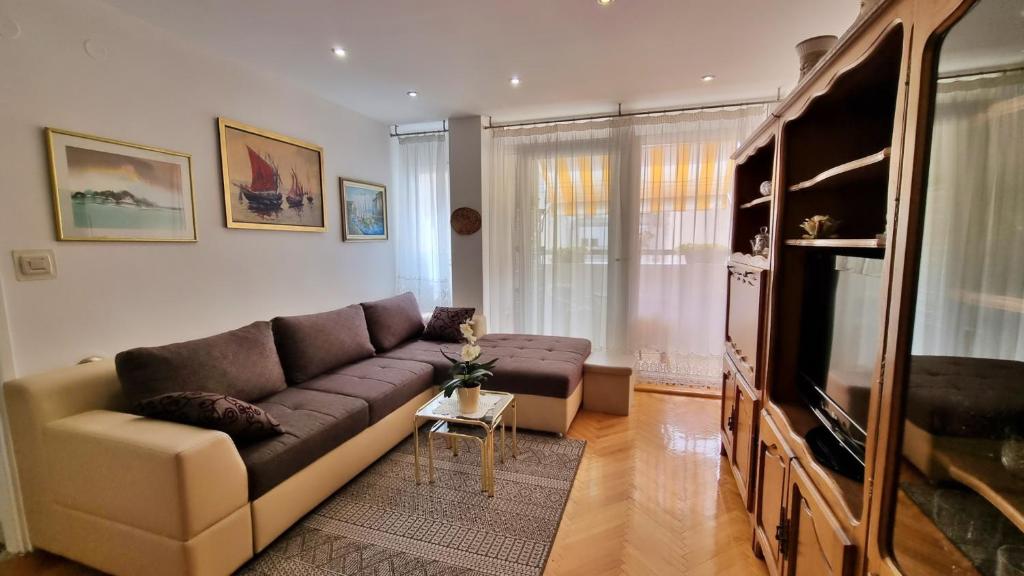 a living room with a couch and a flat screen tv at Apartment Maja in Omiš