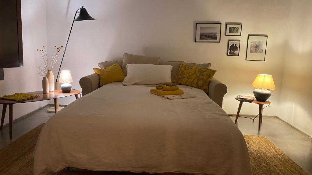 a bedroom with a large bed and a couch at Casa Moni con Vistas al Mar in Playa de Santiago