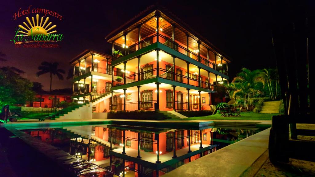 a large house with a pool in front of it at night at Hotel Campestre la Navarra in La Suiza