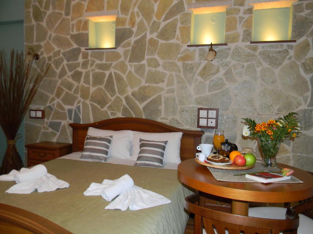 a bedroom with a bed and a table with fruit on it at Agnantio in Ioannina