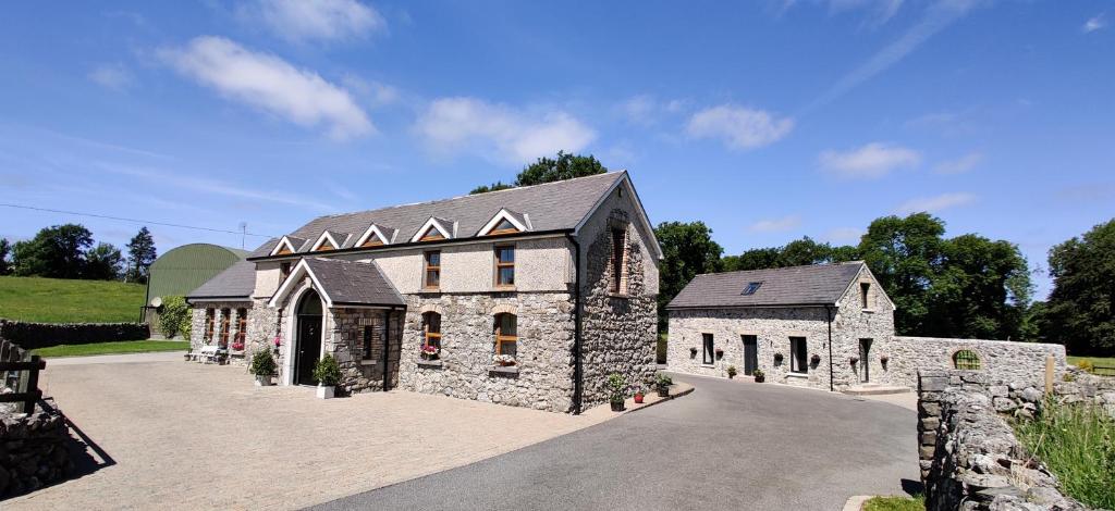 a large stone building with a driveway at Moynure House Boutique B&B & Separate Two bedroom Chalet in Athlone
