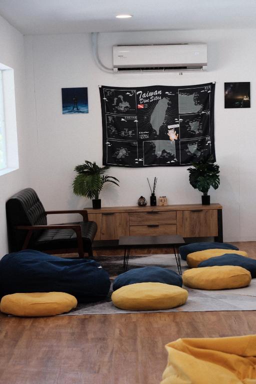 a room with pillows on the floor and a chalkboard at 耶舍 yes sir 潛水旅宿1館2館 in Green Island