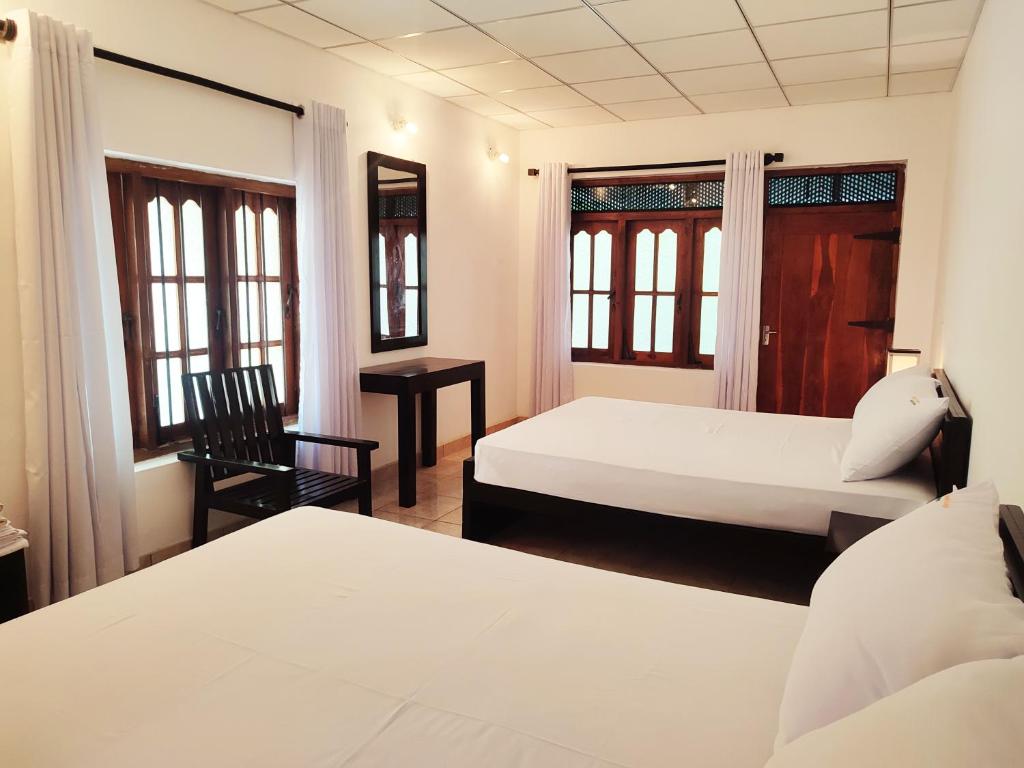 Postel nebo postele na pokoji v ubytování Lakmini Lodge Sigiriya