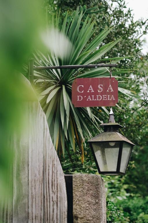a street sign and a street light next to a fence at Casa d'Aldeia de Souto de Lafões OLIVEIRA DE FRADES in Oliveira de Frades