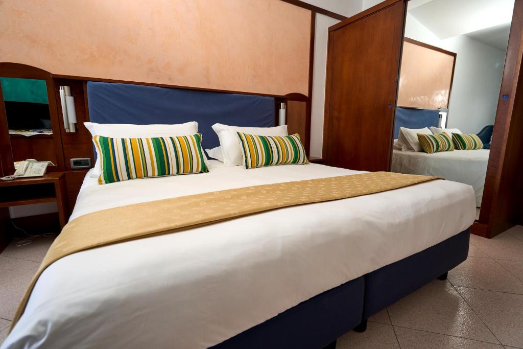 Postel nebo postele na pokoji v ubytování Hotel Graal