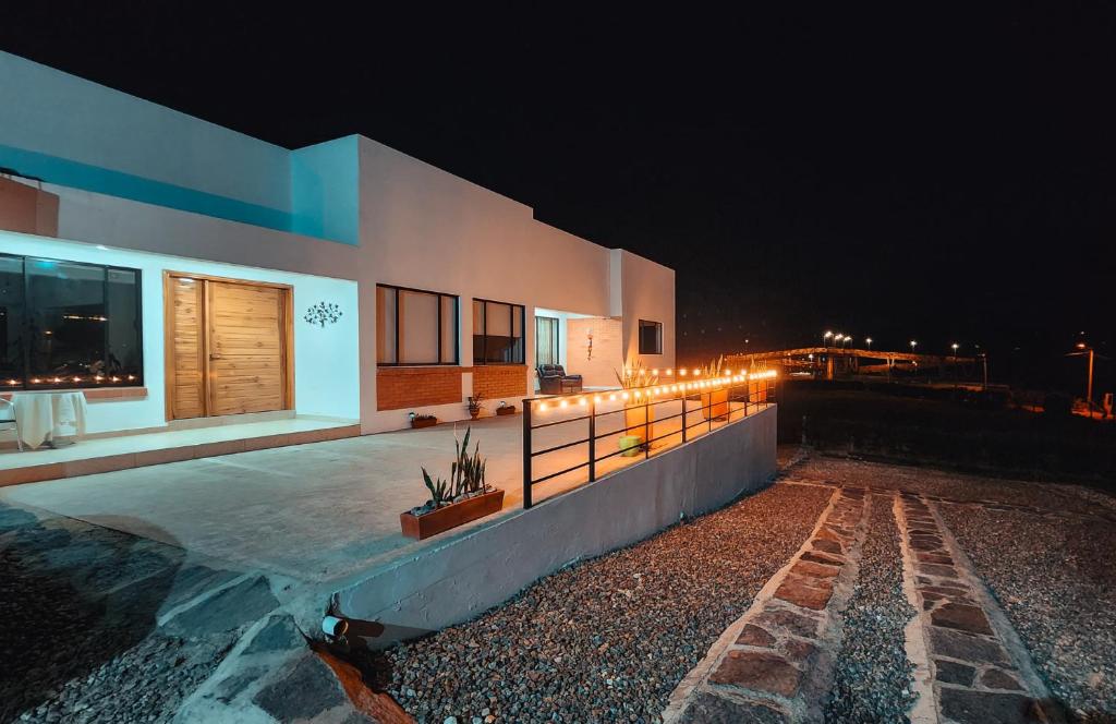 a house with lights on the side of it at night at Casa El Roble paipa in Paipa