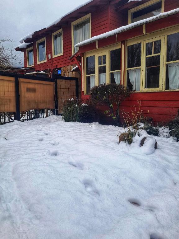 a house with a lot of snow in front of it at Tres Coronas in San Martín de los Andes