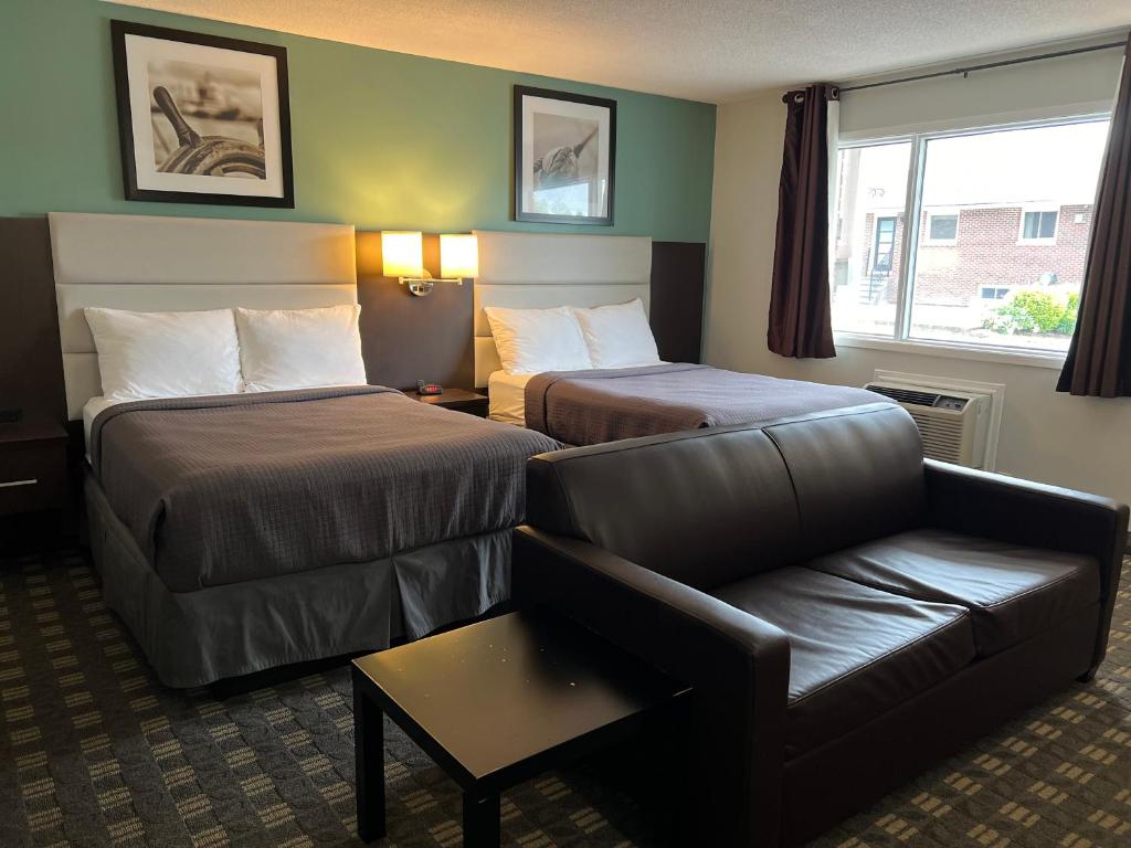 Postel nebo postele na pokoji v ubytování Wellington Inn