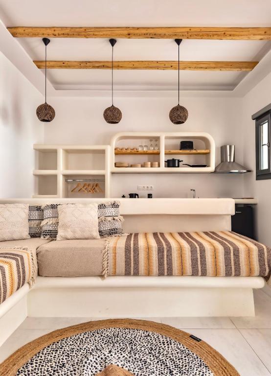 a living room with a couch and shelves at Alonia Suites in Naousa