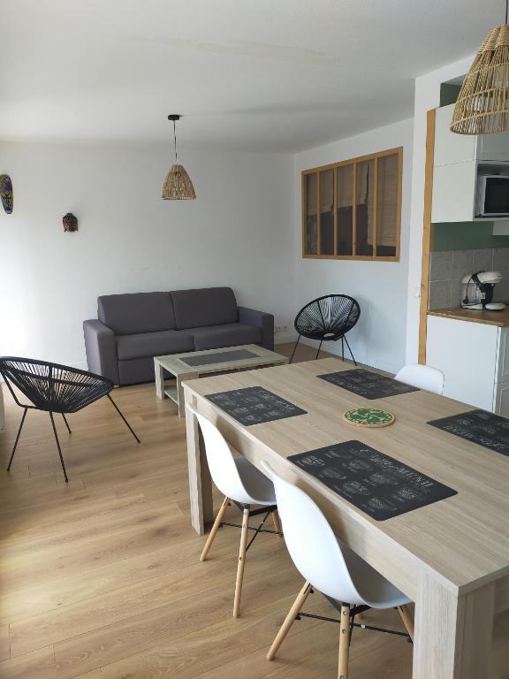 un salon avec une table, des chaises et un canapé dans l'établissement marie, à Anglet