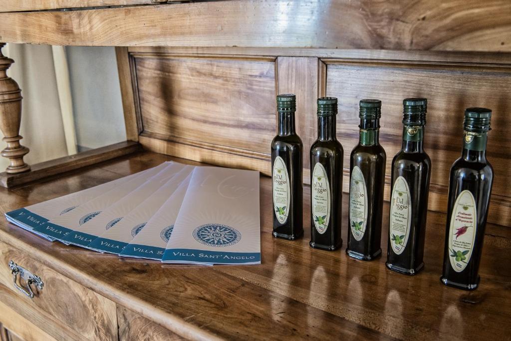 four bottles of wine sitting on a counter with a box at Villa Sant'Angelo in Alba Adriatica