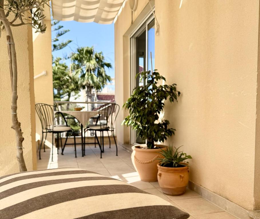 a balcony with potted plants and a table at Apartment Hispamar in Alicante