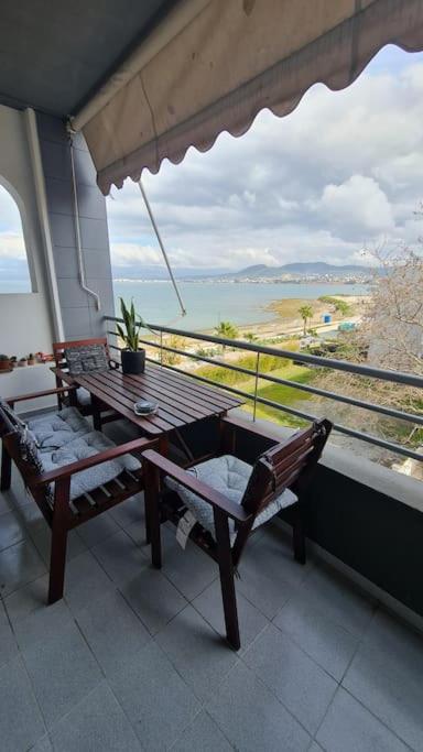 a balcony with a table and a view of the ocean at Seaside Apartment - Charlie's House in Chalkida