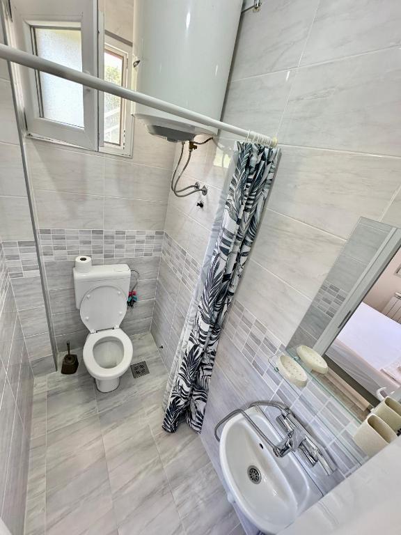 a bathroom with a toilet and a sink at Montenegrina Apartment in Budva