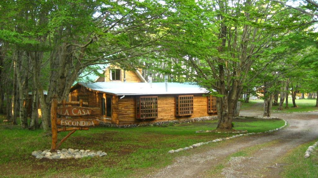 a log cabin with a sign in front of it at La Casa Escondida in Punta Arenas