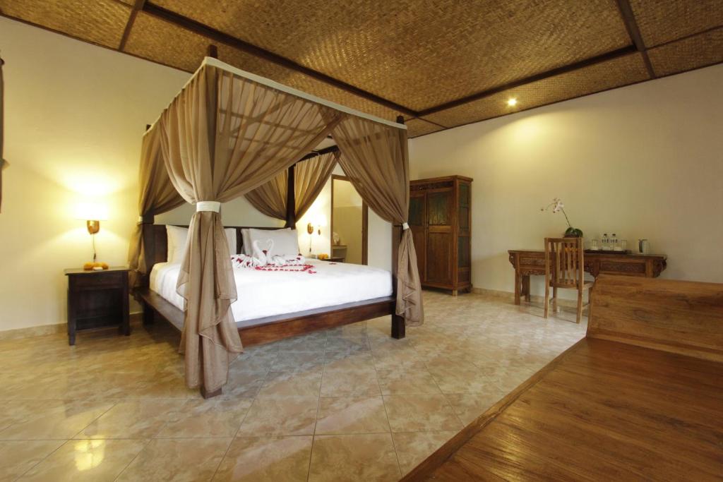 Postel nebo postele na pokoji v ubytování Pekak Mangku Guest House