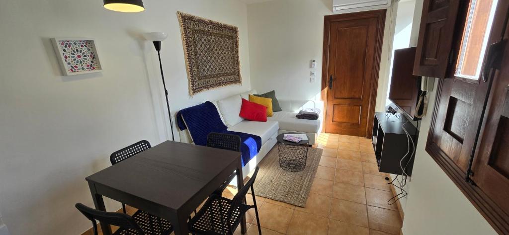 Hotel Casa Ruan Albaicín, Torre de la Vela Atico, duplex, a living room with a blue couch and a table at Casa Ruan Albaicín, Torre de la Vela Atico, duplex in Granada