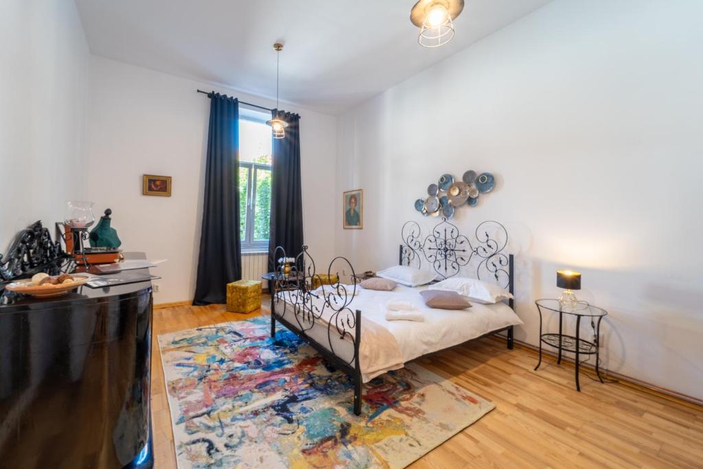 a bedroom with a bed and a rug at Historic 5 star apartment in the main plaza in Cluj-Napoca