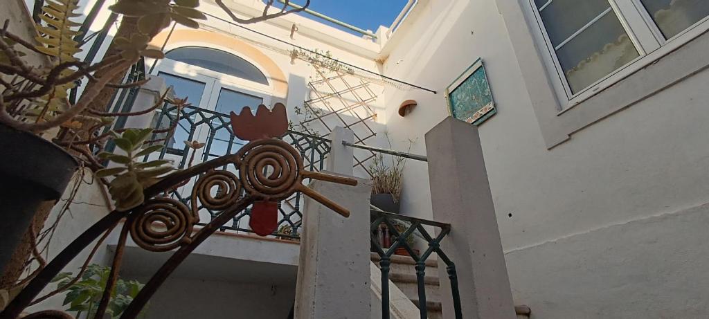 a stairway with a wrought iron railing next to a building at Roof Terrace Apartment in Historical Centre in Tavira