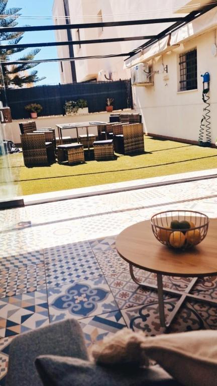 a room with a table and chairs and a patio at El Paraíso de Fuentebravía - Primera Línea de Playa in El Puerto de Santa María