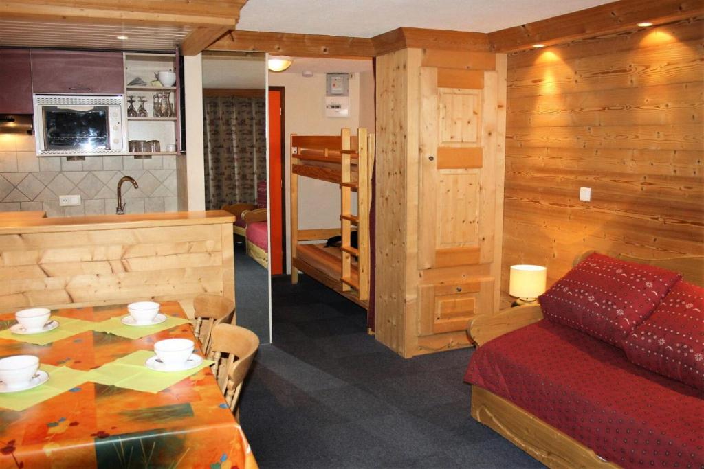 Cette chambre comprend une table, un lit et une cuisine. dans l'établissement Résidence Palafour - Grand studio 4 - confortable - balcon - vue lac MAE-3696, à Tignes