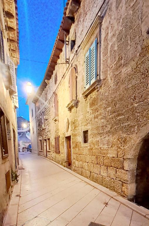 an empty alley in an old stone building at Dignano in Vodnjan