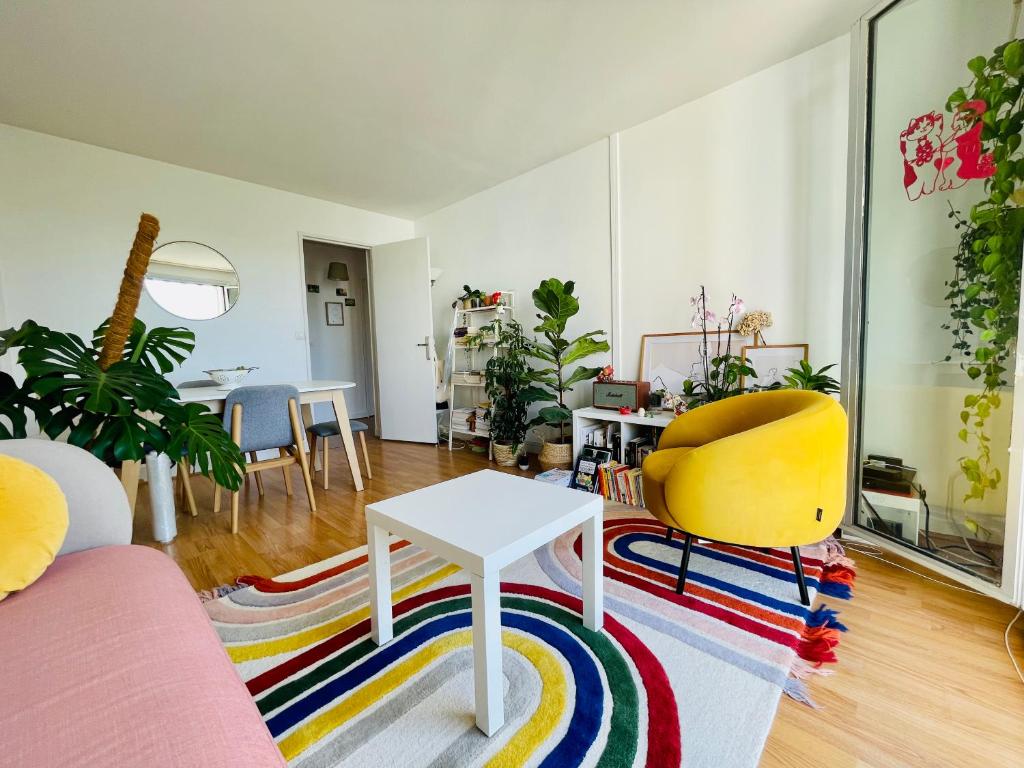 a living room with a couch and a table and chairs at cozy two bed room flat near Champs-Élysée in Rueil-Malmaison