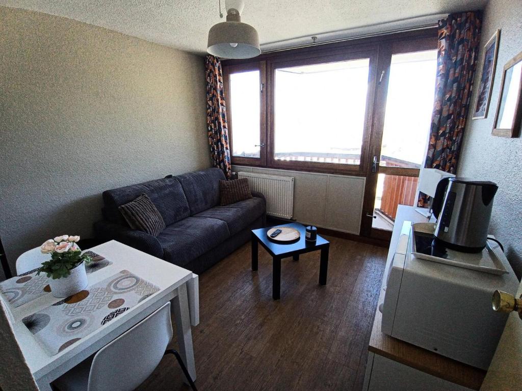 un salon avec un canapé et une table dans l'établissement Résidence Le France - Studio 2 personnes Plagne Centre MAE-2844, à Aime La Plagne