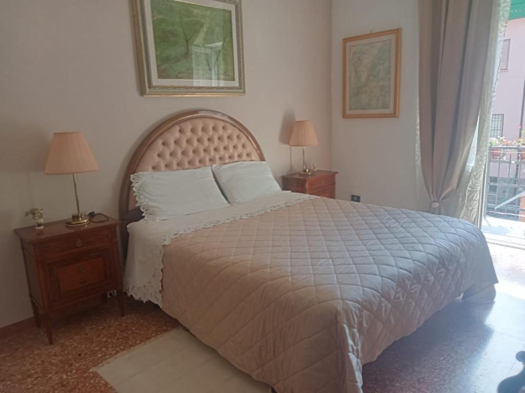 a bedroom with a bed and two night stands with lamps at La Casa di Paola in Graffignano