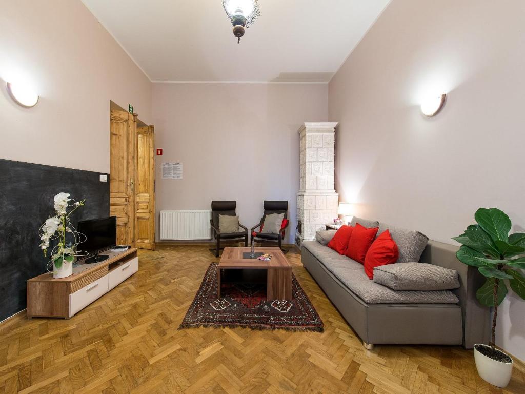 a living room with a couch and a tv at 5 Bedroom Family Apartment in Krakow