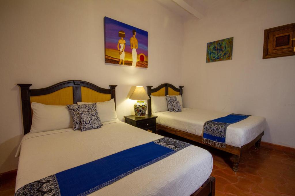 Postel nebo postele na pokoji v ubytování Hotel del Sol
