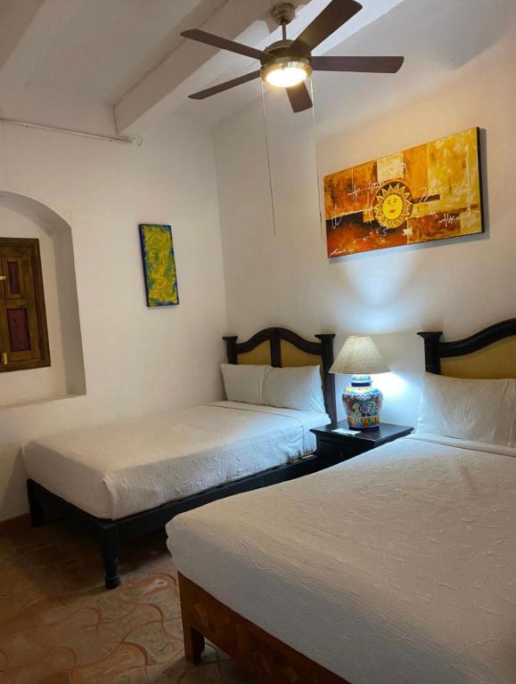 Postel nebo postele na pokoji v ubytování Hotel del Sol