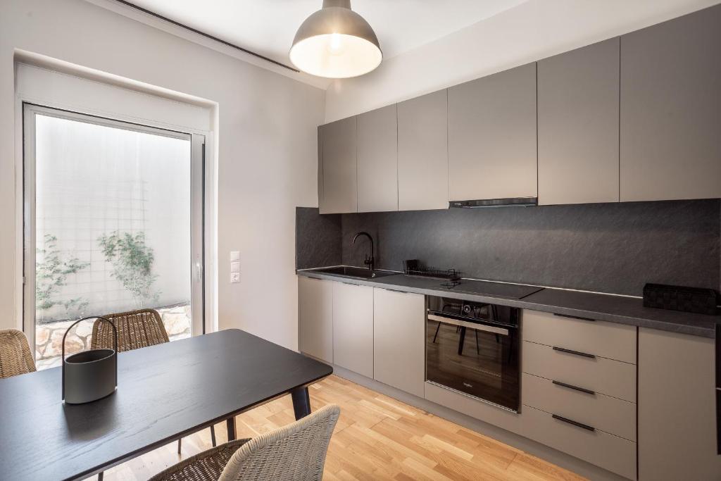 a kitchen with a table and a dining room at NIMA Village in Paleros