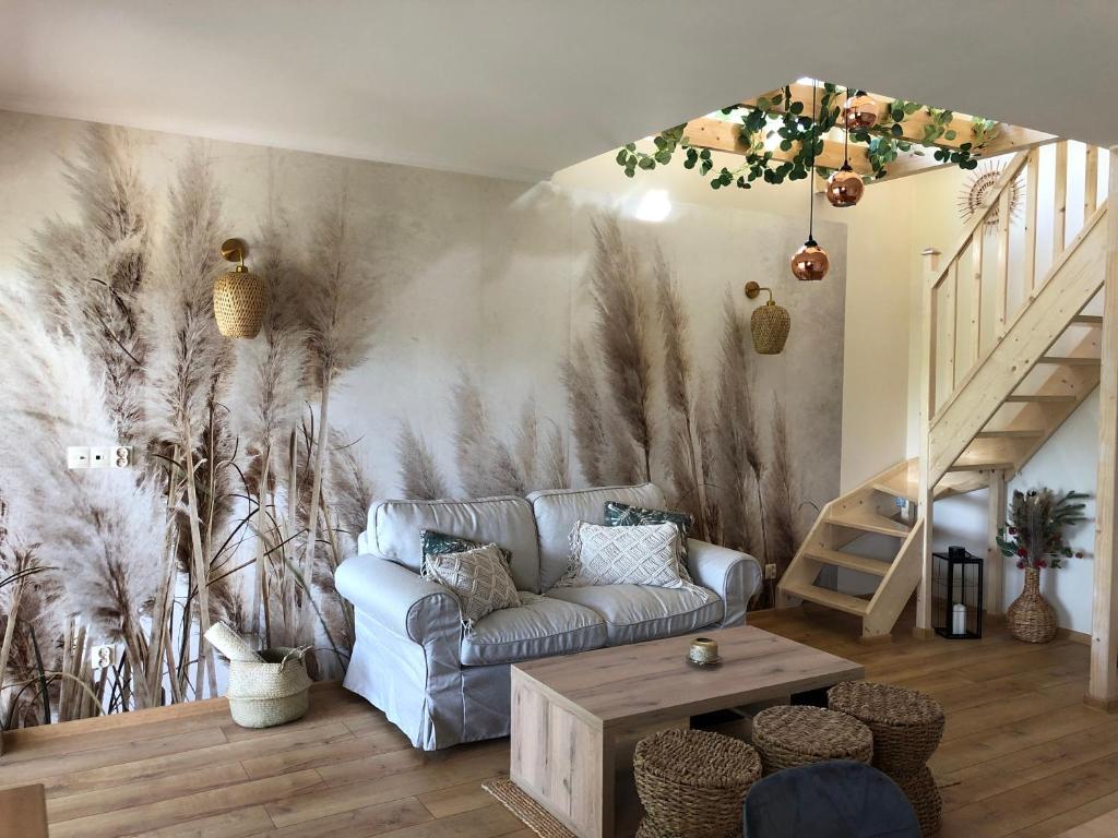a living room with a couch and a wall mural at LakeHouse nad Jeziorem Żywieckim in Żywiec
