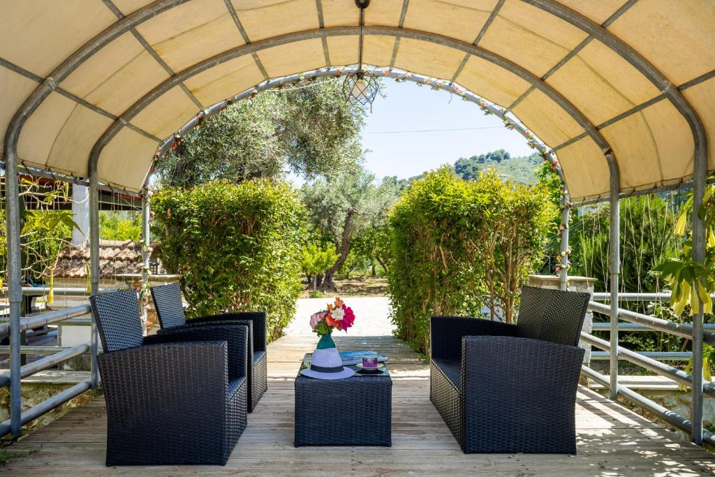 a group of chairs and a table under a tent at Blue Butterfly in Skopelos Town
