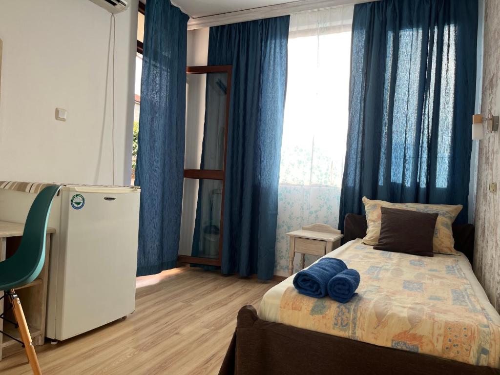 A bed or beds in a room at Paunovi Guest House
