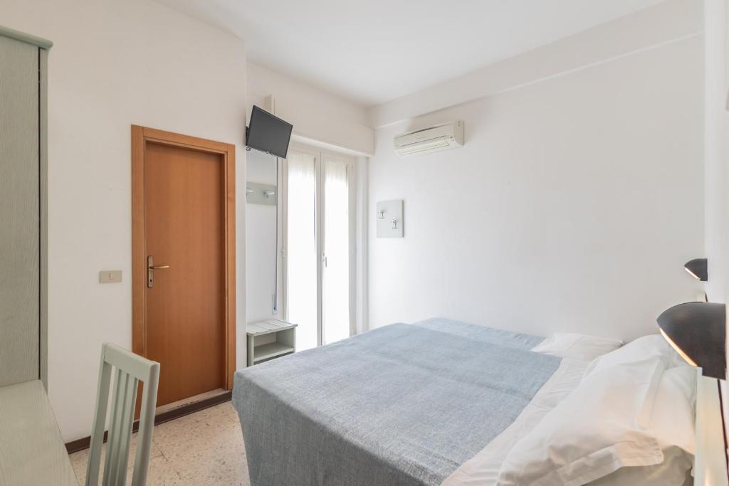 Postel nebo postele na pokoji v ubytování Hotel leonardo