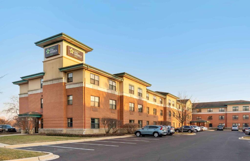 a building with a clock tower next to a parking lot at Extended Stay America Suites - Chicago - Vernon Hills - Lake Forest in Vernon Hills