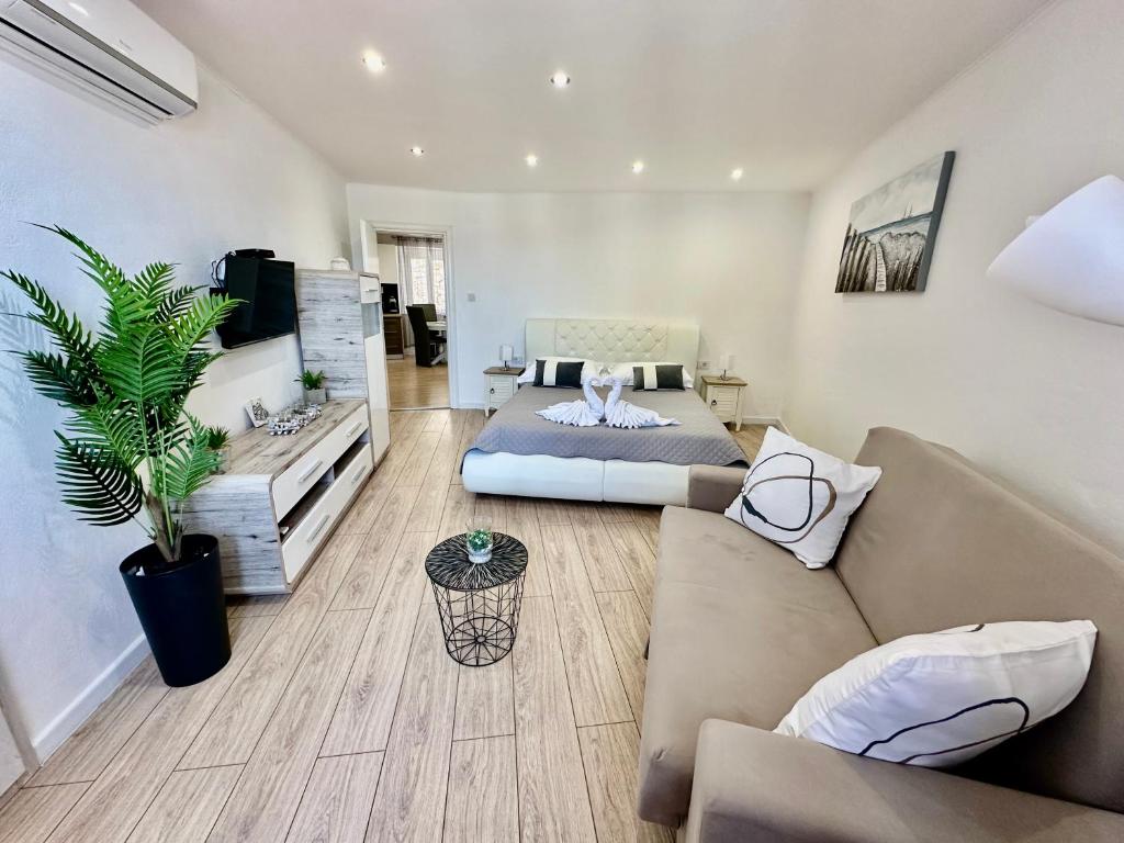 a living room with a couch and a table at Primadonna Apartments in Šibenik