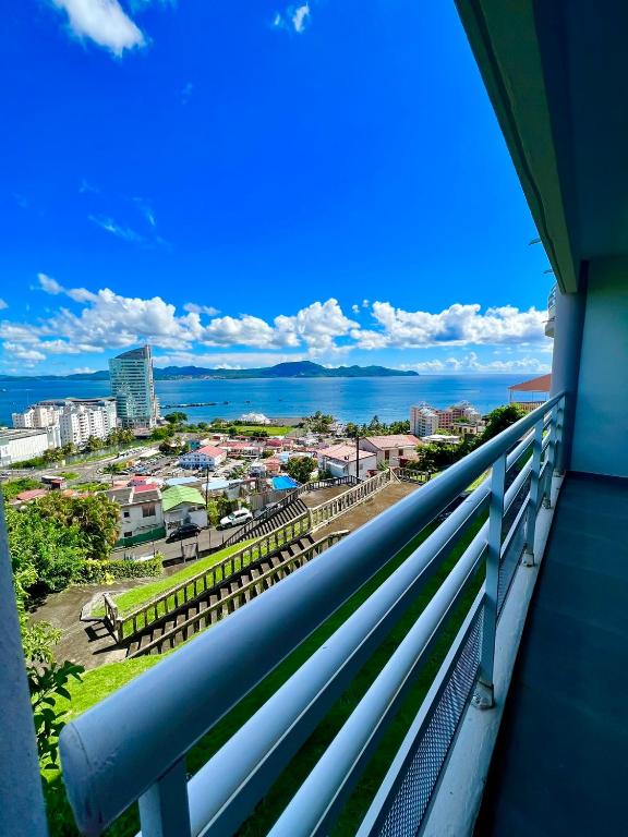 a balcony with a view of the city at Escapade Panoramique Appt prestige vue mer in Fort-de-France