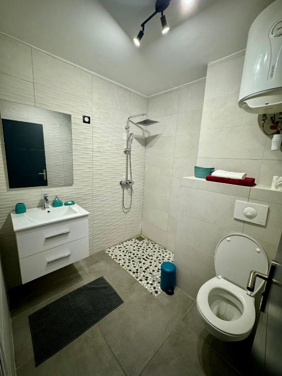 a bathroom with a toilet and a sink at Escapade Panoramique Appt prestige vue mer in Fort-de-France