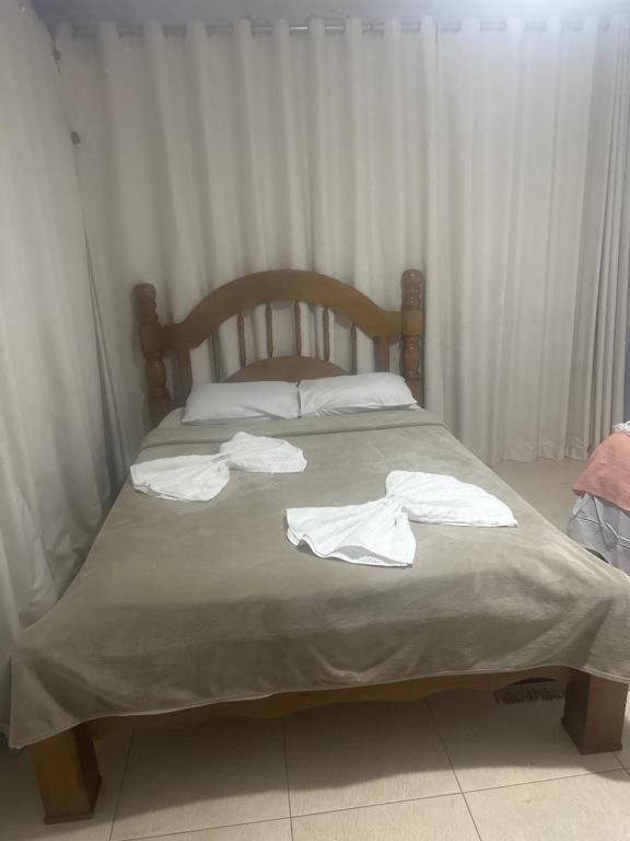 a bed with white towels on top of it at Hotel Pousada Irmaos Freyhardt in Rio de Janeiro