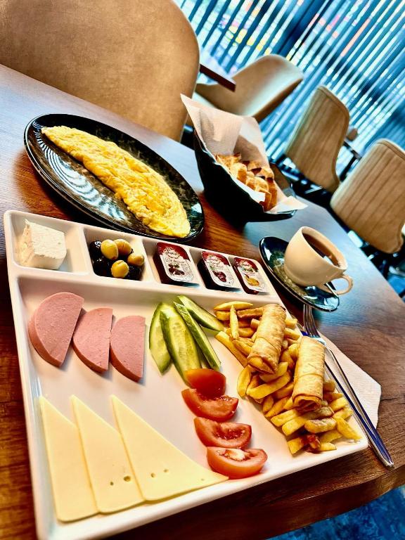 a tray of cheese and vegetables on a table at Skymoon Istanbul Airport Hotel in Arnavutköy