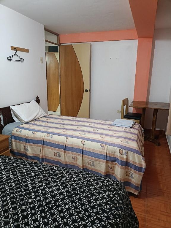 Voodi või voodid majutusasutuse Hostal Ayllu toas