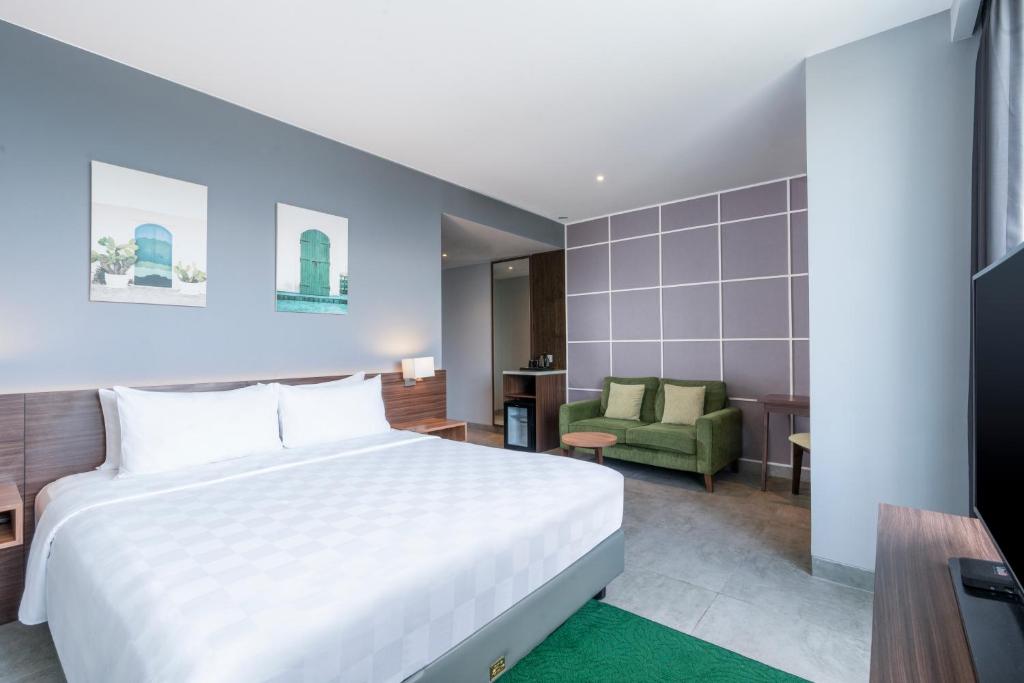 Postel nebo postele na pokoji v ubytování Swiss-Belinn Bogor