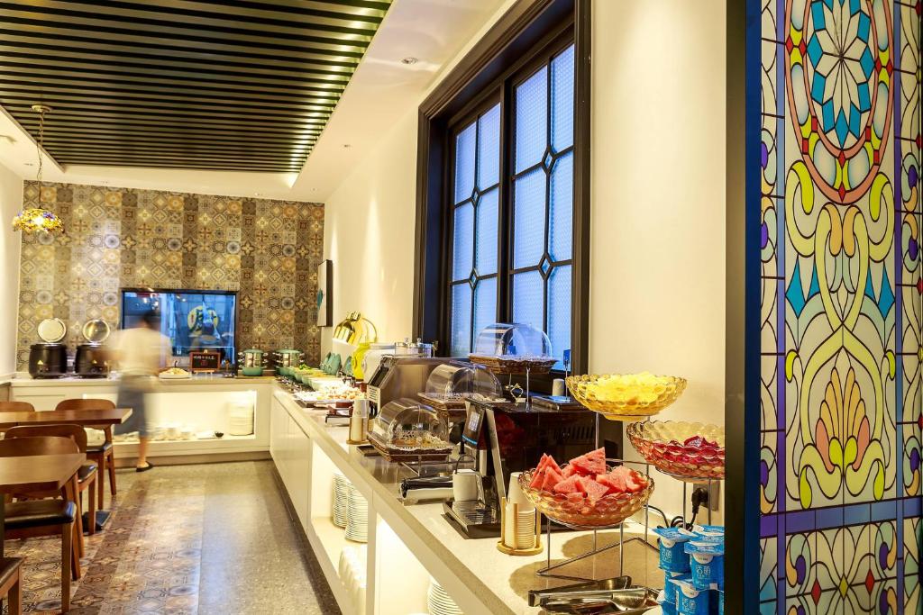a kitchen with a long counter with a counter top at Nost algia S Hotel Near Chengdu Kuanzhai Alley - People's Park, Chengdu Panda Base, 10 minutes walk to subway , Free laundry, English communication well, Free coffee,Free travel advice in Chengdu