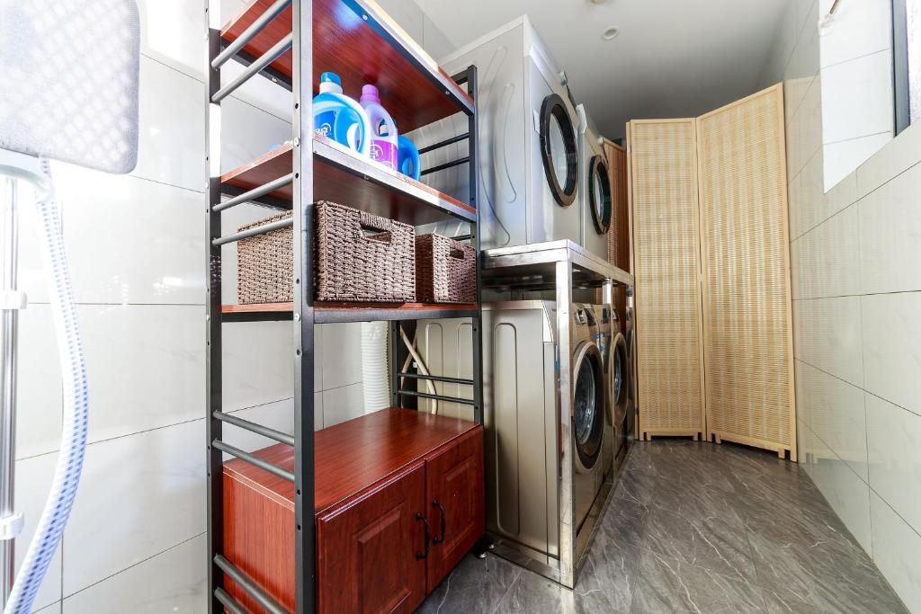 a laundry room with a washer and dryer at Nost algia S Hotel Near Chengdu Kuanzhai Alley - People's Park, Chengdu Panda Base, 10 minutes walk to subway , Free laundry, English communication well, Free coffee,Free travel advice in Chengdu