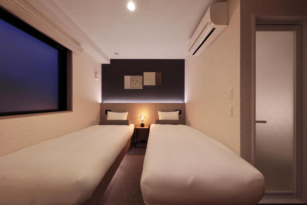Postel nebo postele na pokoji v ubytování Doutonbori Crystal Hotel IV