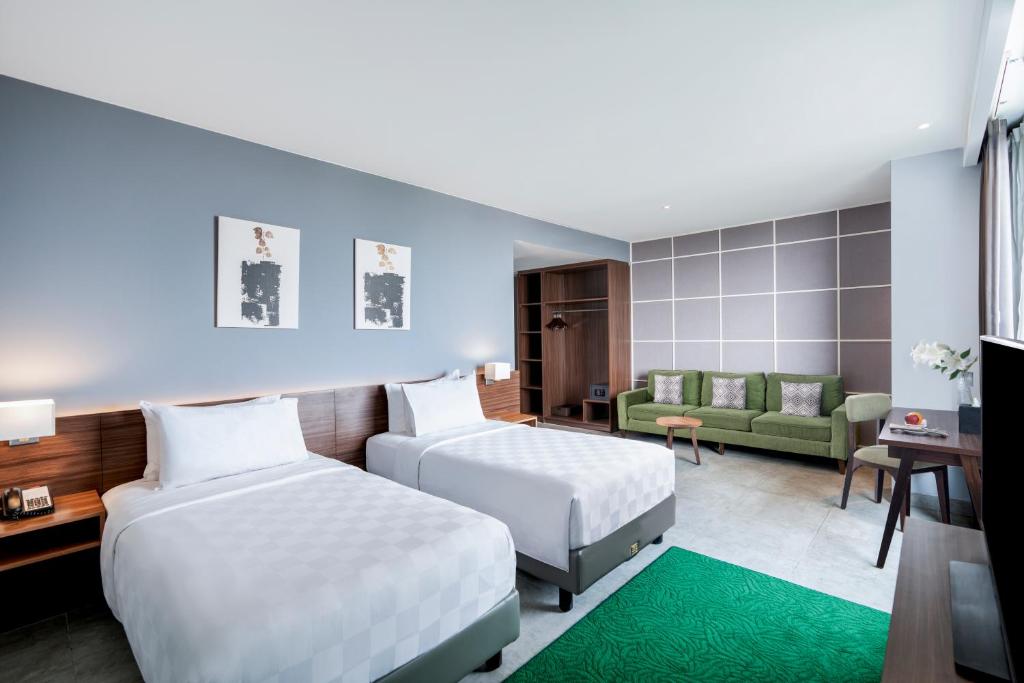 Postel nebo postele na pokoji v ubytování Swiss-Belinn Bogor