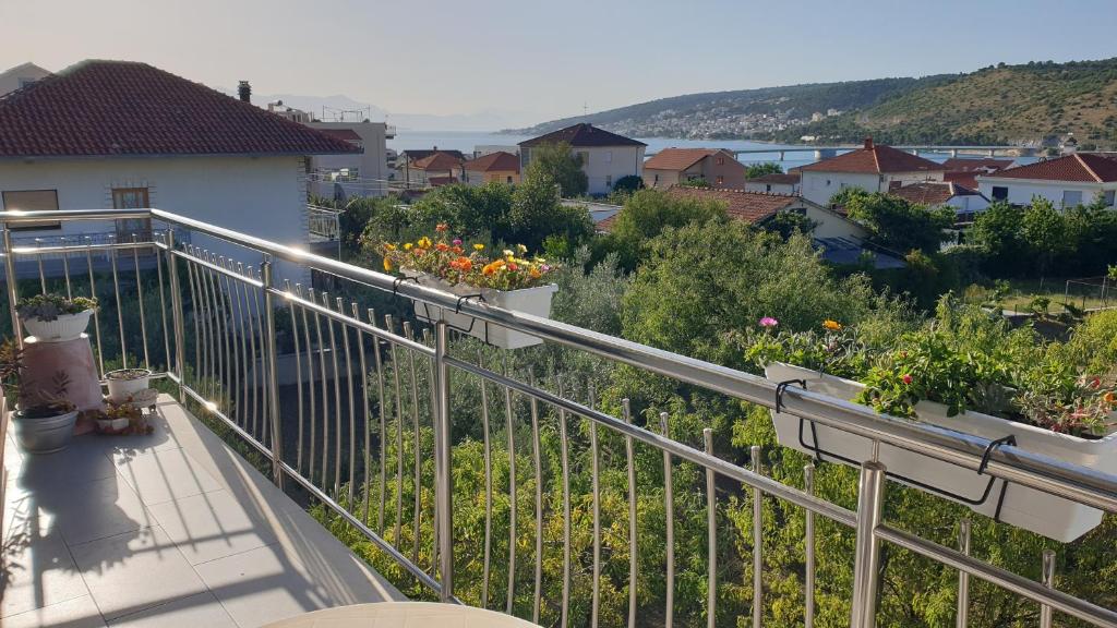 a balcony with flowers inpots on a house at Astralis in Trogir